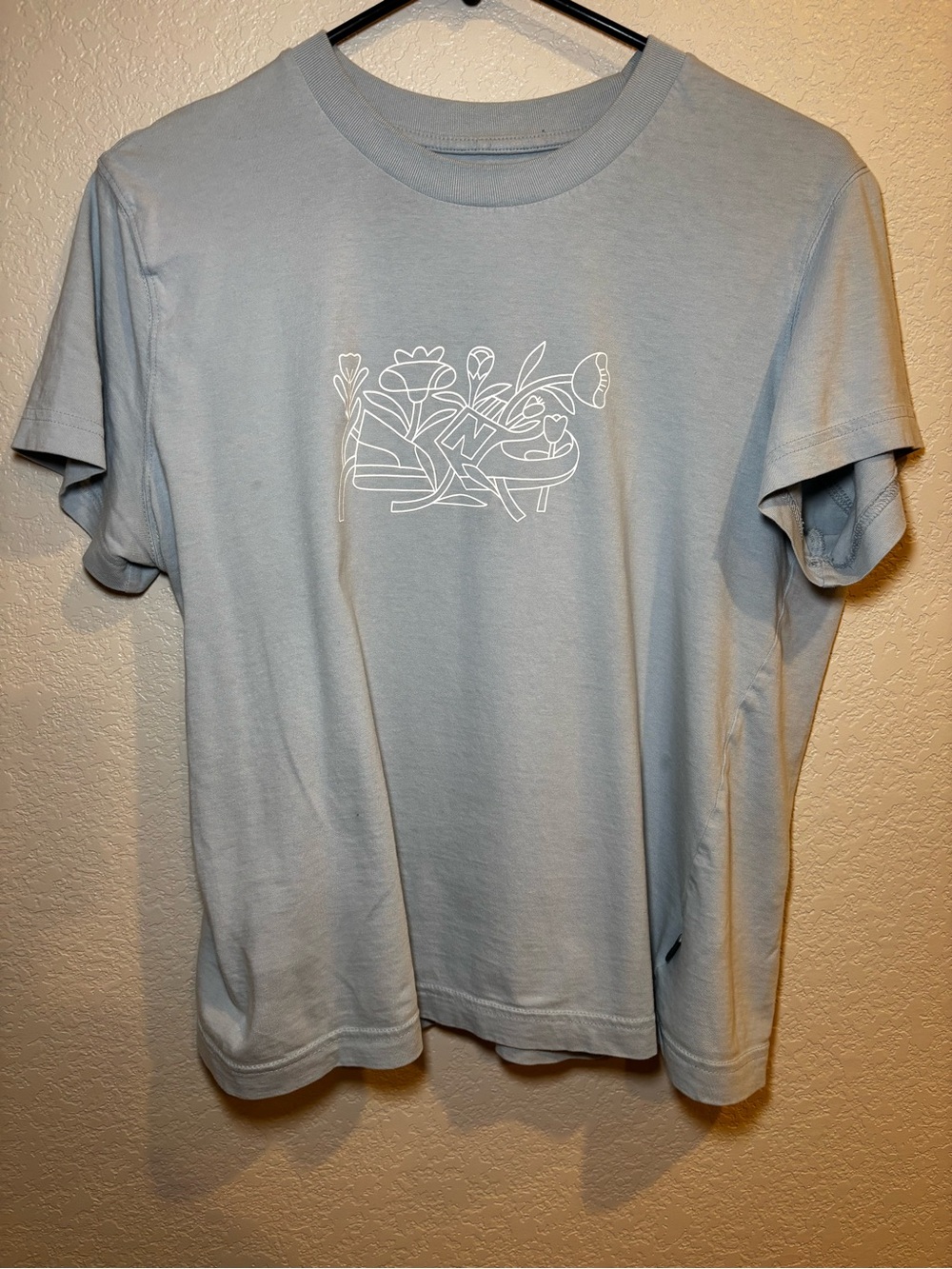 New Balance Light Blue Crewneck Tee with White Floral Graphic